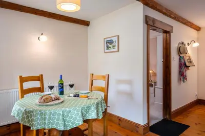 a dining room table with a plate of food on it at Wheal Kitty nr Truro in Truro