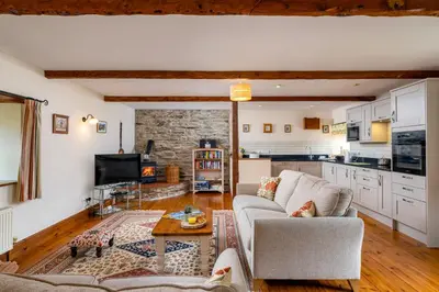 a living room with a couch and a table at Wheal Kitty nr Truro in Truro