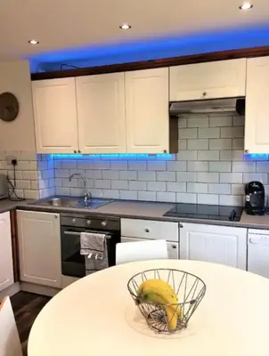 a kitchen with a bowl of bananas on a table at Springer Villa, 2 bed, Newquay in Newquay