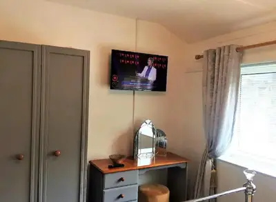 a flat screen tv on the corner of a room at Springer Villa, 2 bed, Newquay in Newquay
