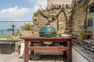 a green pot sitting on top of a wooden table at Award Winning 5* BEACH HOUSE! Hot Tub & Fire Pit in Portreath