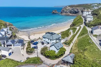 an aerial view of a house and the beach at Award Winning 5* BEACH HOUSE! Hot Tub & Fire Pit in Portreath