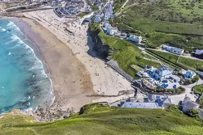 an aerial view of a beach and the ocean at Award Winning 5* BEACH HOUSE! Hot Tub & Fire Pit in Portreath
