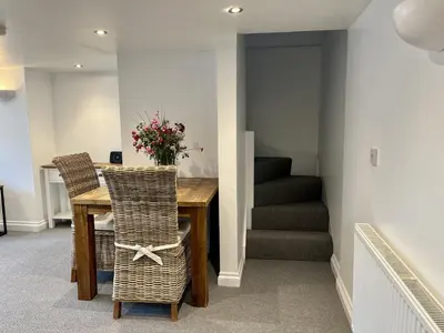 a dining room with a table and two chairs at The Coach House - with hot tub in St Austell