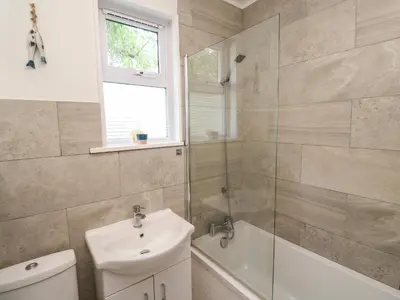 a bathroom with a sink and a toilet and a shower at 8 Rosewall Cottages in St Ives