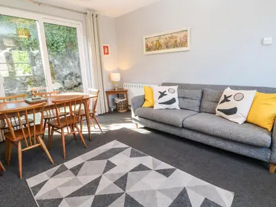 a living room with a couch and a table at 8 Rosewall Cottages in St Ives