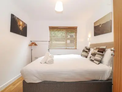 a bedroom with a large white bed with two stuffed animals on it at Garras in Truro