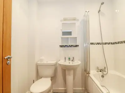 a bathroom with a toilet and a sink and a shower at Tehidy in Truro