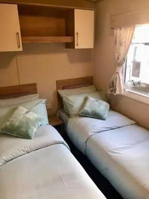 two beds in a small room with a window at Newquay Cornwall Holiday Rental in Newquay