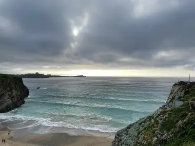 a view of the ocean with people on the beach at Newquay Cornwall Holiday Rental in Newquay