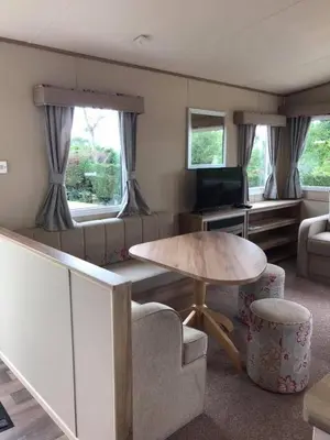 a living room with a table and a couch at Newquay Cornwall Holiday Rental in Newquay
