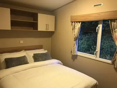 a bedroom with two beds and a window at Newquay Cornwall Holiday Rental in Newquay