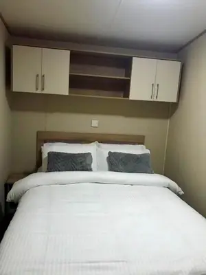 a bedroom with a large white bed with two pillows at Newquay Cornwall Holiday Rental in Newquay