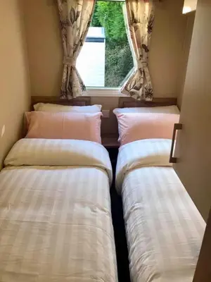 three beds in a small room with a window at Newquay Cornwall Holiday Rental in Newquay