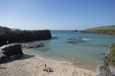 a group of people on a beach near the water at Sunshine Cottage, Padstow in Padstow