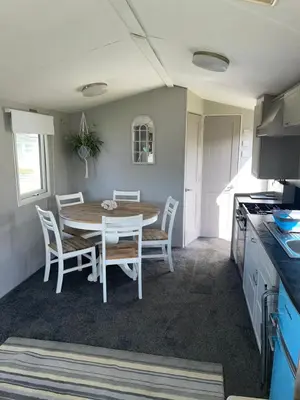a kitchen and dining room with a table and chairs at 93 Newquay Bay resort Pet friendly in Newquay