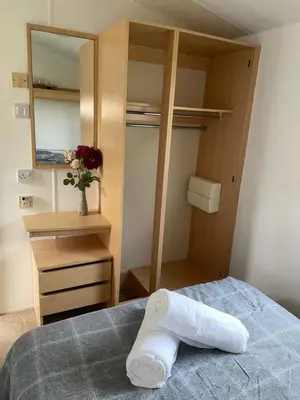 a roll of toilet paper on a bed in a bedroom at 93 Newquay Bay resort Pet friendly in Newquay