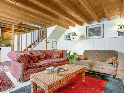a living room with a couch and a table at Hallowarren Barn in Saint Anthony