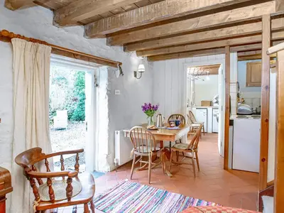 a kitchen and dining room with a table and chairs at Hallowarren Barn in Saint Anthony