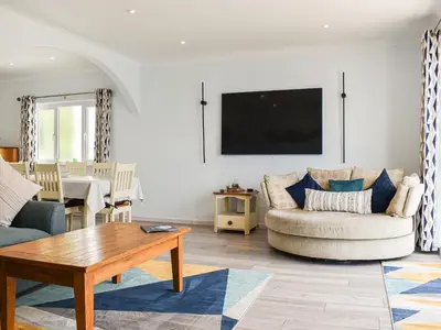 a living room with a couch and a table at The Dawn in Looe