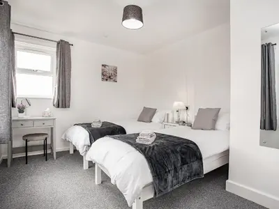 two beds in a room with white walls at Number One in Saint Dennis