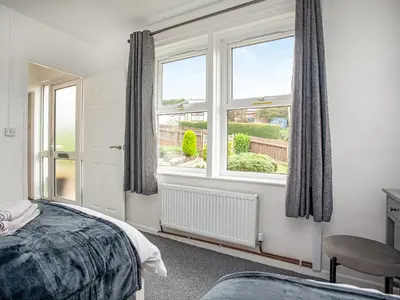 a bedroom with a bed and a large window at Number One in Saint Dennis