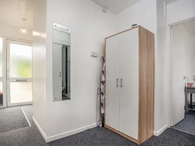 a room with a wardrobe and a mirror on the wall at Number One in Saint Dennis