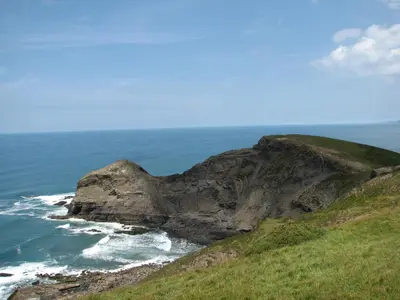 a large rock in the ocean next to the ocean at Woodgate in Bude