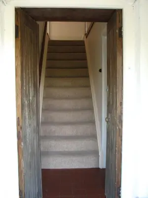 a staircase leading up to a room with a stair case at Woodgate in Bude
