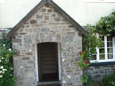 a small brick dog house with a window at Woodgate in Bude