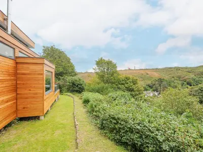 a wooden house on the side of a hill at 9 Cedars in St. Agnes