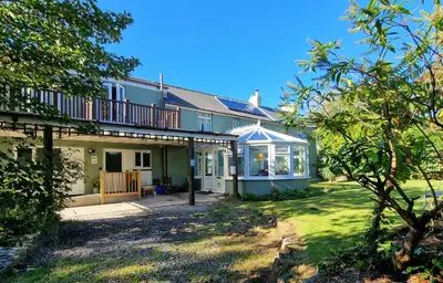 a house with a gazebo in a yard at Goonearl Simply Stay in Scorrier