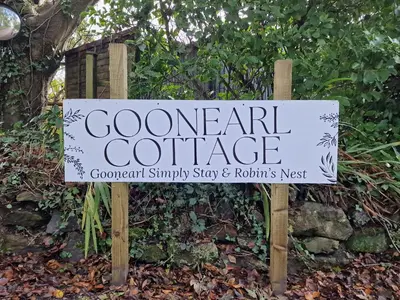 a sign for a garden center in a garden at Goonearl Simply Stay in Scorrier