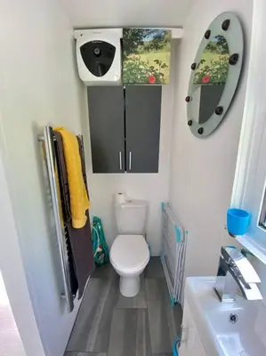 a small bathroom with a toilet and a sink at Guest house Truro garden retreat in Kenwyn
