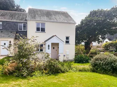 a white house with a yard at Merizac in Budock Water