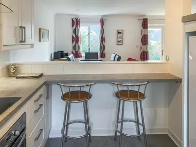 a kitchen with two bar stools at a counter at Merizac in Budock Water