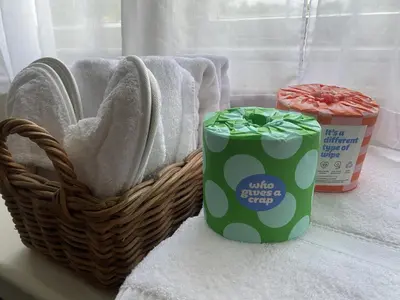 a basket of towels and a can of glue and a container of cleaner at Costislost House in Wadebridge