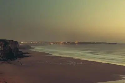 a view of a beach at night with the ocean at Mabyn in Porth