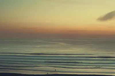 a view of the ocean from a beach at sunset at Mabyn in Porth