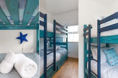 two bunk beds in a room with a blue ceiling at Floyd's in St Ives