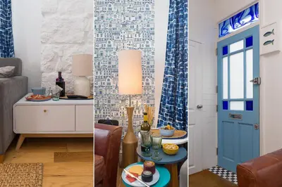 a living room with a blue door and a table with food at Floyd's in St Ives