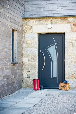 a pair of red boots standing in front of a garage at Cedar Lodge in Carbis Bay
