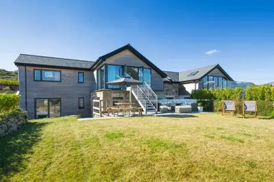 a large house with a lawn in front of it at Cedar Lodge in Carbis Bay