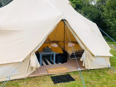 a large white tent with a table in it at Rose in St Austell