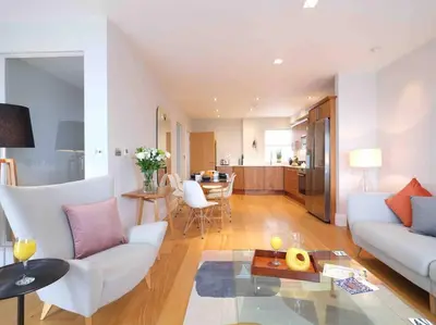 a living room with a couch and a table at Luxurious apartment, 180° beach views & parking in St Ives