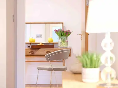 a chair in front of a desk with a mirror at Luxurious apartment, 180° beach views & parking in St Ives