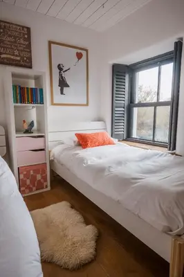 a bedroom with two twin beds and a window at The Farmhouse in Porth