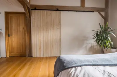 a bedroom with a bed and a potted plant at The Farmhouse in Porth
