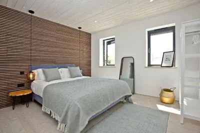 a bedroom with a large bed and a window at Rockpools in Porth