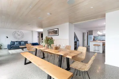 a dining room and living room with a table and chairs at Watersend in Porth